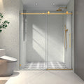 Brushed gold frameless sliding shower door with soft-close hardware — image 1